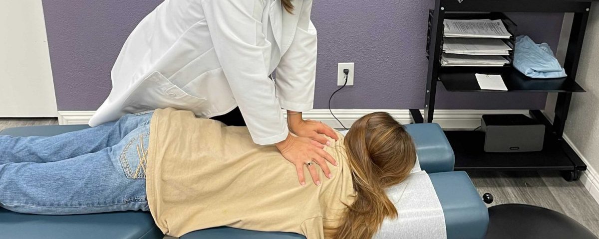Dr. Amber performing a chiropractic adjustment at Voitenko Wellness Tustin CA